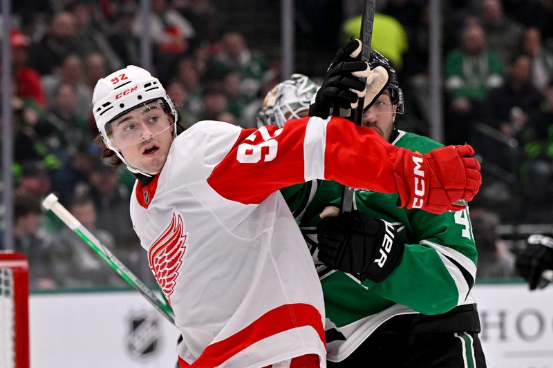 Jan 19, 2025; Dallas, Texas, USA; Detroit Red Wings center Marco Kasper (92) and Dallas Stars defenseman Ilya Lyubushkin (46) battle for position in the Stars crease during the first period at the American Airlines Center. Mandatory Credit: Jerome Miron-Imagn Images