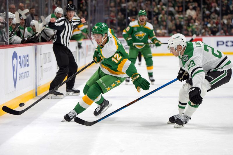 Nov 16, 2024; Saint Paul, Minnesota, USA; Minnesota Wild left wing Matt Boldy (12) skates along the boards against Dallas Stars defenseman Esa Lindell (23) in the first period at Xcel Energy Center. Mandatory Credit: Matt Blewett-Imagn Images