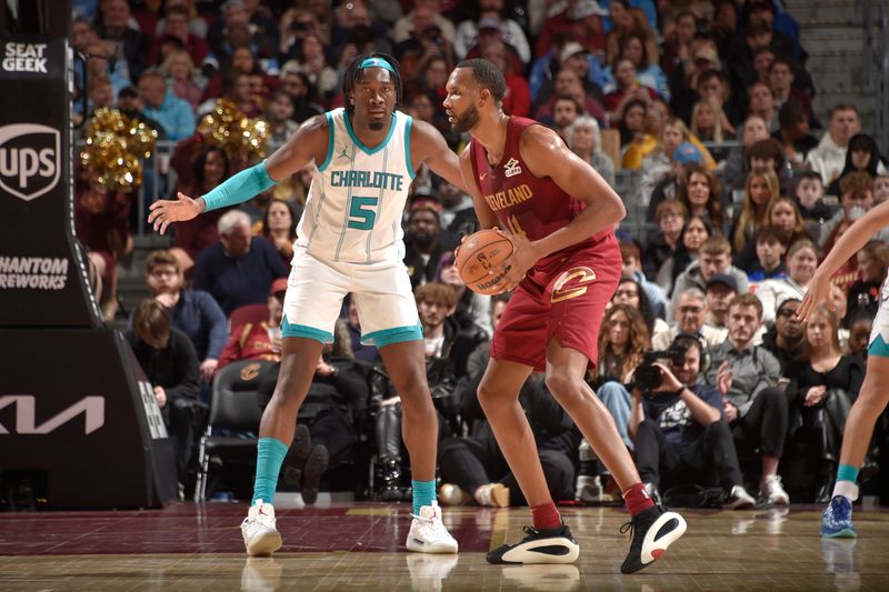 CLEVELAND, OH - JANUARY 5: Evan Mobley #4 of the Cleveland Cavaliers handles the ball during the game against the Charlotte Hornets on January 5, 2025 at Rocket Mortgage FieldHouse in Cleveland, Ohio. NOTE TO USER: User expressly acknowledges and agrees that, by downloading and/or using this Photograph, user is consenting to the terms and conditions of the Getty Images License Agreement. Mandatory Copyright Notice: Copyright 2025 NBAE (Photo by David Liam Kyle/NBAE via Getty Images)