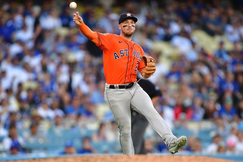 Jun 25, 2023; Los Angeles, California, USA; Houston Astros third baseman Alex Bregman (2) throws to first for the out against Los Angeles Dodgers catcher Will Smith (16) during the eleventh inning at Dodger Stadium. Mandatory Credit: Gary A. Vasquez-USA TODAY Sports