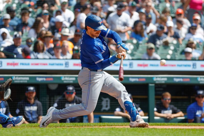 May 26, 2024; Detroit, Michigan, USA; Toronto Blue Jays catcher Danny Jansen (9) hits during an at bat in the first inning of the game against the Detroit Tigers at Comerica Park. Mandatory Credit: Brian Bradshaw Sevald-USA TODAY Sports