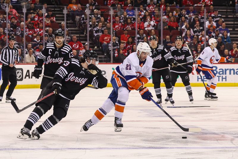 Apr 15, 2024; Newark, New Jersey, USA; New York Islanders center Kyle Palmieri (21) skates with the puck against the New Jersey Devils during the third period at Prudential Center. Mandatory Credit: Ed Mulholland-USA TODAY Sports