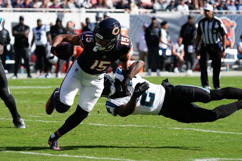 Chicago Bears wide receiver Rome Odunze (15) sheds the tackle of Carolina Panthers cornerback Michael Jackson (2) during the second half of an NFL football game Sunday, Oct. 6, 2024, in Chicago. (AP Photo/Nam Y. Huh)