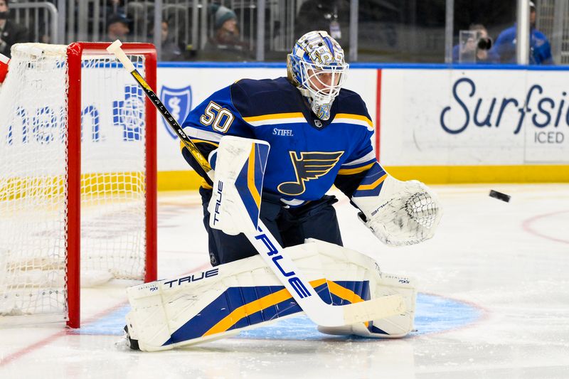 Mar 20, 2025; St. Louis, Missouri, USA;  St. Louis Blues goaltender Jordan Binnington (50) defends the net against the Vancouver Canucks during the first period at Enterprise Center. Mandatory Credit: Jeff Curry-Imagn Images