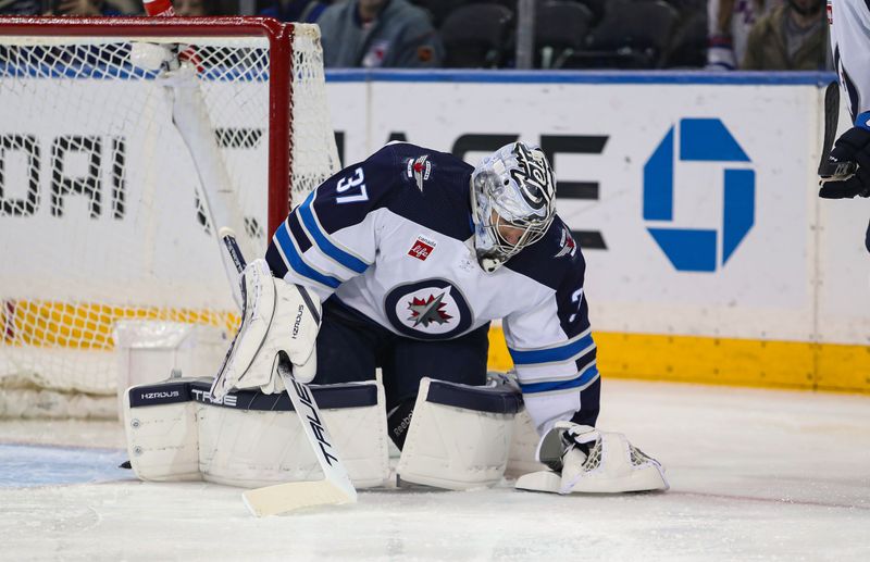 Mar 19, 2024; New York, New York, USA; Winnipeg Jets goalie Connor Hellebuyck (37) makes a save against the New York Rangers during the first period at Madison Square Garden. Mandatory Credit: Danny Wild-USA TODAY Sports