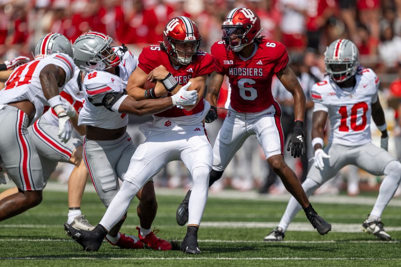 Sep 2, 2023; Bloomington, Indiana, USA; Indiana Hoosiers quarterback Brendan Sorsby (15) is tackled by Ohio State Buckeyes safety Sonny Styles (6) during the first quarter at Memorial Stadium. Mandatory Credit: Marc Lebryk-USA TODAY Sports