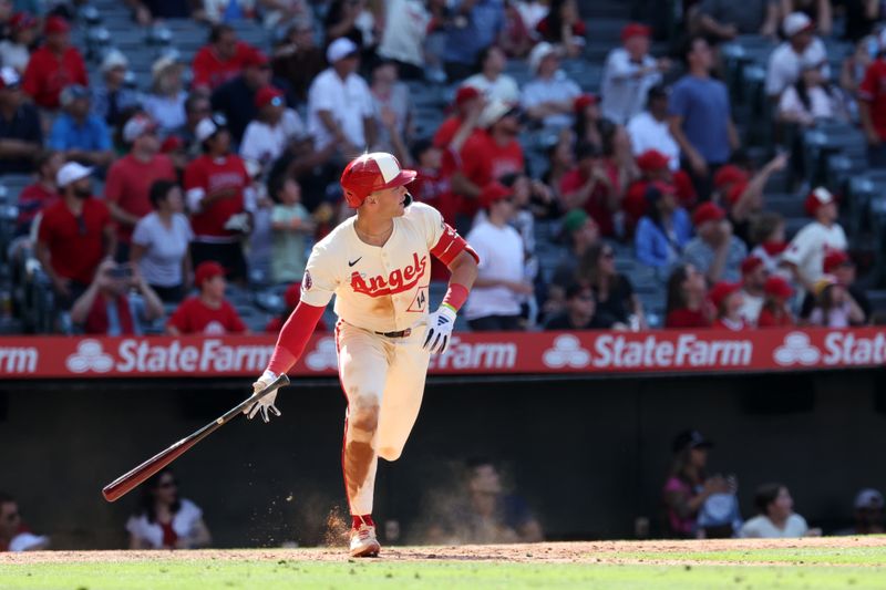 Jun 9, 2024; Anaheim, California, USA;  Los Angeles Angels catcher Logan O'Hoppe (14) hits a game winning 2-run home run in bottom of the ninth inning against the Houston Astros at Angel Stadium. Mandatory Credit: Kiyoshi Mio-USA TODAY Sports