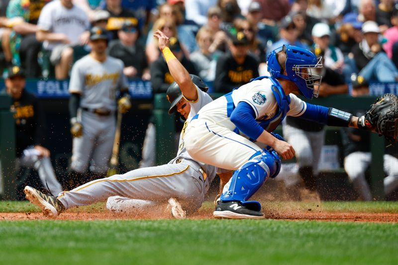 May 28, 2023; Seattle, Washington, USA; Pittsburgh Pirates center fielder Ji Hwan Bae (3, left) slides home to score a run on a sacrifice fly by catcher Austin Hedges (18, not pictured) against Seattle Mariners catcher Tom Murphy (2) during the fifth inning at T-Mobile Park. Mandatory Credit: Joe Nicholson-USA TODAY Sports