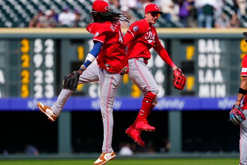 Apr 27, 2025; Denver, Colorado, USA; Cincinnati Reds shortstop Elly De La Cruz (44) and left fielder Austin Hays (12) celebrate defeating the Colorado Rockies at Coors Field. Mandatory Credit: Ron Chenoy-Imagn Images