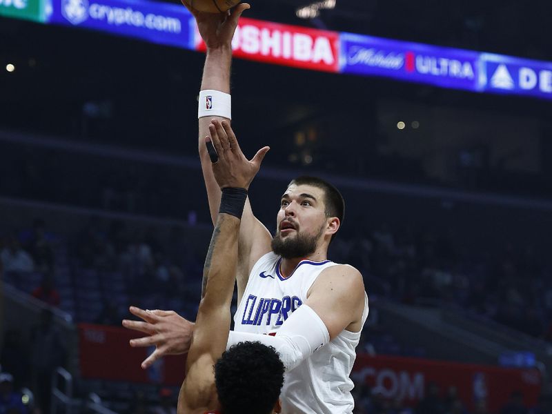 LOS ANGELES, CALIFORNIA - DECEMBER 11:  Ivica Zubac #40 of the LA Clippers takes a shot against Toumani Camara #33 of the Portland Trail Blazers in the first half at Crypto.com Arena on December 11, 2023 in Los Angeles, California.  NOTE TO USER: User expressly acknowledges and agrees that, by downloading and/or using this photograph, user is consenting to the terms and conditions of the Getty Images License Agreement. (Photo by Ronald Martinez/Getty Images)