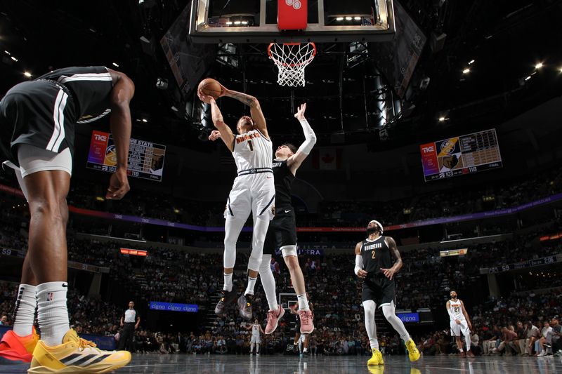 MEMPHIS, TN - APRIL 14:  Michael Porter Jr. #1 of the Denver Nuggets drives to the basket during the game against the Memphis Grizzlies on April 14, 2024 at FedExForum in Memphis, Tennessee. NOTE TO USER: User expressly acknowledges and agrees that, by downloading and or using this photograph, User is consenting to the terms and conditions of the Getty Images License Agreement. Mandatory Copyright Notice: Copyright 2024 NBAE (Photo by Joe Murphy/NBAE via Getty Images)