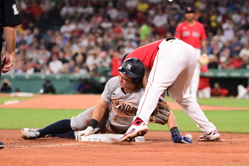 Jun 14, 2024; Boston, Massachusetts, USA; New York Yankees shortstop Anthony Volpe (11) reacts after stealing third base during the fifth inning against the Boston Red Sox at Fenway Park. Mandatory Credit: Eric Canha-USA TODAY Sports