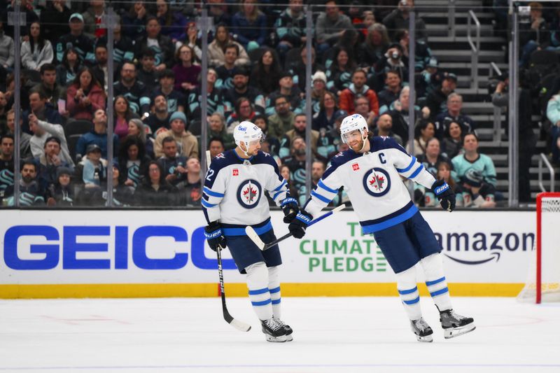 Mar 8, 2024; Seattle, Washington, USA; Winnipeg Jets right wing Nino Niederreiter (62) and center Adam Lowry (17) celebrate after Lowry scored a goal against the Seattle Kraken during the third period at Climate Pledge Arena. Mandatory Credit: Steven Bisig-USA TODAY Sports