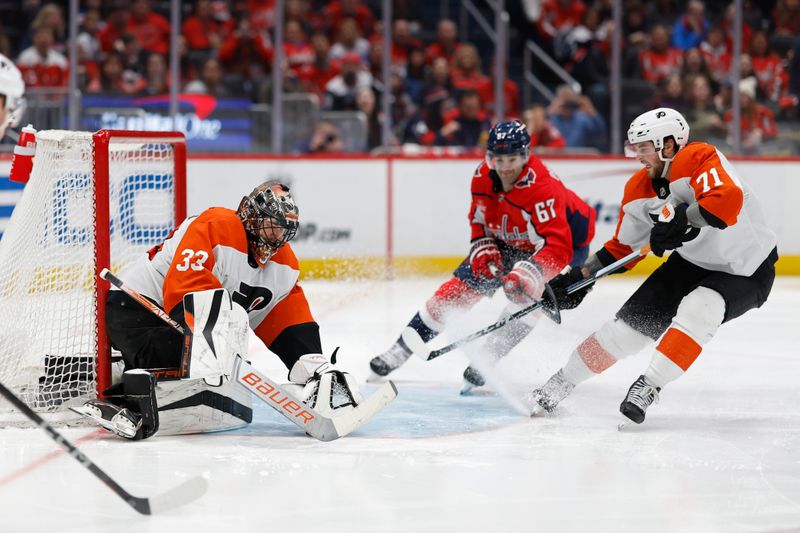 Mar 1, 2024; Washington, District of Columbia, USA; Philadelphia Flyers goaltender Samuel Ersson (33) covers the puck in front of Washington Capitals left wing Max Pacioretty (67) and Flyers right wing Tyson Foerster (71) in the third period at Capital One Arena. Mandatory Credit: Geoff Burke-USA TODAY Sports