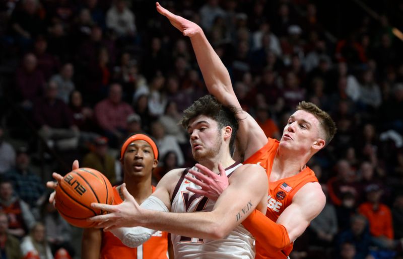 Jan 28, 2023; Blacksburg, Virginia, USA; Virginia Tech Hokies forward Grant Basile (21) grabs ball as Syracuse Orange guard Justin Taylor (5) right and forward Maliq Brown (1) defend in the second half at Cassell Coliseum. Mandatory Credit: Lee Luther Jr.-USA TODAY Sports