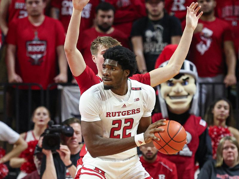 Feb 10, 2024; Piscataway, New Jersey, USA; Rutgers Scarlet Knights center Emmanuel Ogbole (22) controls the ball against Wisconsin Badgers forward Nolan Winter (31)  during the first half at Jersey Mike's Arena. Mandatory Credit: Vincent Carchietta-USA TODAY Sports