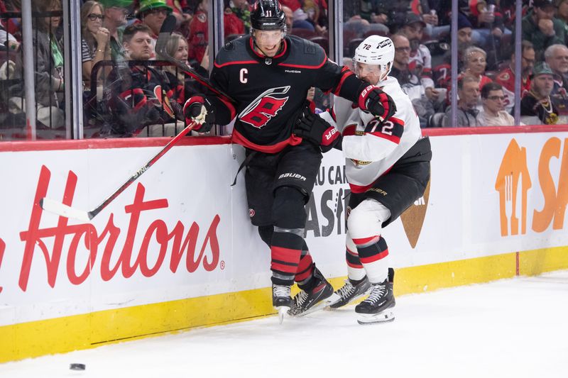 Mar 17, 2024; Ottawa, Ontario, CAN; Carolina Hurricanes center Jordan Staal (11) gets past Ottawa Senators defenseman Thomas Chabot (72) in the second period at the Canadian Tire Centre. Mandatory Credit: Marc DesRosiers-USA TODAY Sports