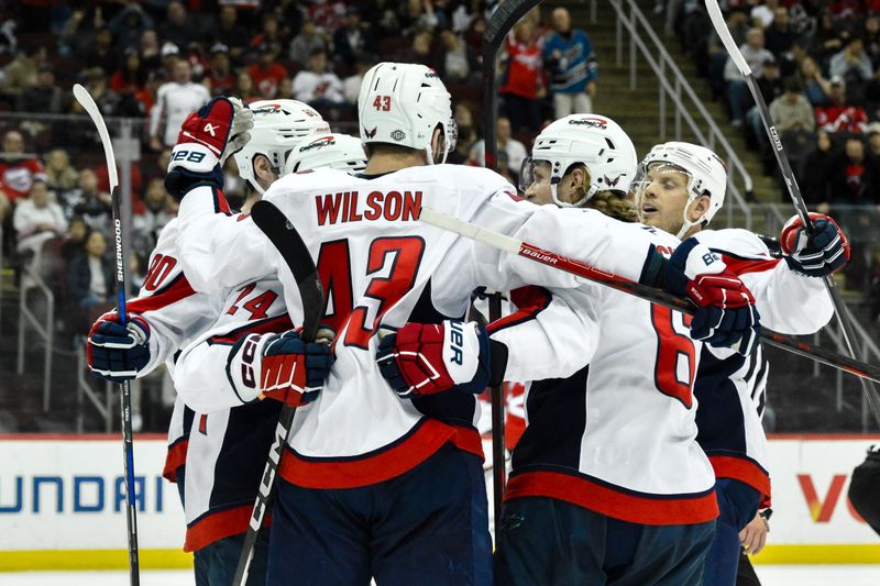 Oct 19, 2024; Newark, New Jersey, USA; Washington Capitals center Connor McMichael (24) celebrates with teammates after scoring a goal against the New Jersey Devils during the first period at Prudential Center. Mandatory Credit: John Jones-Imagn Images