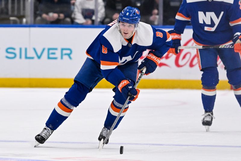 Mar 5, 2024; Elmont, New York, USA;  New York Islanders defenseman Noah Dobson (8) skates with the puck against the St. Louis Blues during the second period at UBS Arena. Mandatory Credit: Dennis Schneidler-USA TODAY Sports