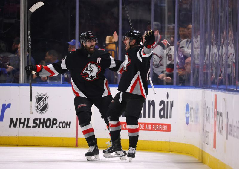 Nov 1, 2024; Buffalo, New York, USA;  Buffalo Sabres center Ryan McLeod (71) celebrates his goal with right wing Alex Tuch (89) during the third period against the New York Islanders at KeyBank Center. Mandatory Credit: Timothy T. Ludwig-Imagn Images