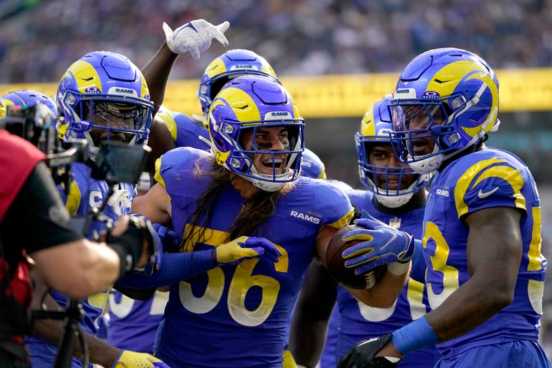 Los Angeles Rams linebacker Christian Rozeboom (56) celebrates with teammates after intercepting a pass during the second half of an NFL football game against the Arizona Cardinals Sunday, Oct. 15, 2023, in Inglewood, Calif. (AP Photo/Ashley Landis)