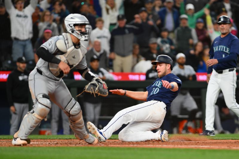 Jun 12, 2024; Seattle, Washington, USA; Seattle Mariners left fielder Luke Raley (20) scores the game-winning run against the Chicago White Sox during the tenth inning at T-Mobile Park. Mandatory Credit: Steven Bisig-USA TODAY Sports