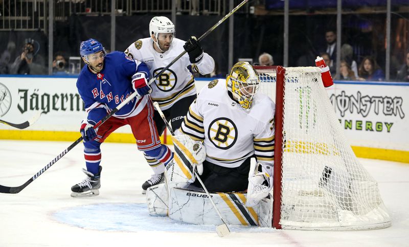 Nov 25, 2023; New York, New York, USA; Boston Bruins goalie  Linus Ullmark (35) guards the net while New York Rangers center Vincent Trocheck (16) and Boston Bruins defenseman Derek Forbort (28) battle for position during the second period at Madison Square Garden. Mandatory Credit: Danny Wild-USA TODAY Sports