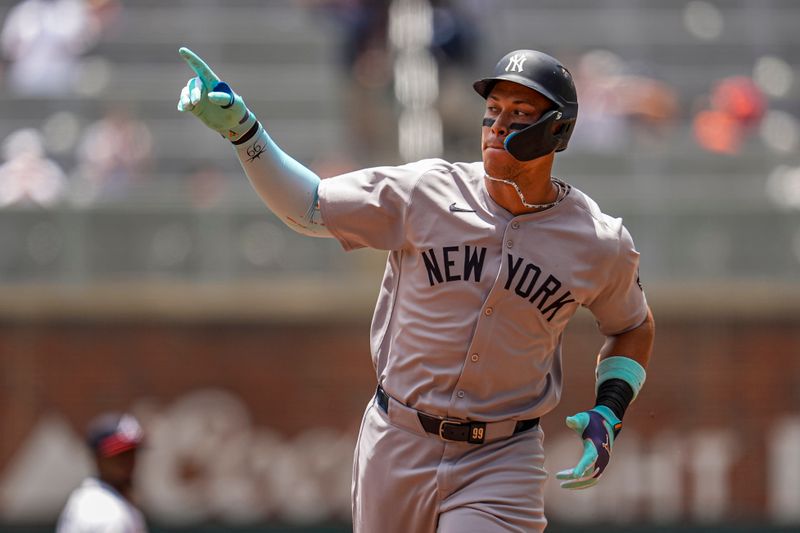 Jul 20, 2025; Cumberland, Georgia, USA; New York Yankees right fielder Aaron Judge (99) runs after hitting a home run against the Atlanta Braves during the first inning at Truist Park. Mandatory Credit: Dale Zanine-Imagn Images