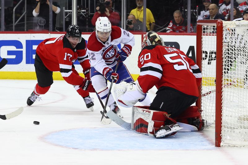 Jan 17, 2024; Newark, New Jersey, USA; Montreal Canadiens right wing Cole Caufield (22) loses the puck in front of New Jersey Devils goaltender Nico Daws (50) during the third period at Prudential Center. Mandatory Credit: Ed Mulholland-USA TODAY Sports