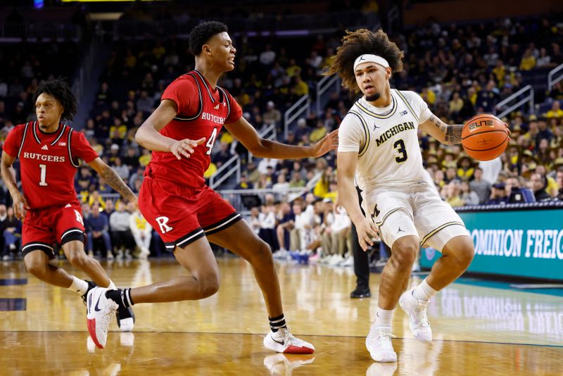 Feb 27, 2025; Ann Arbor, Michigan, USA;  Michigan Wolverines guard Tre Donaldson (3) dribbles defended by Rutgers Scarlet Knights guard Ace Bailey (4) at Crisler Center. Mandatory Credit: Rick Osentoski-Imagn Images