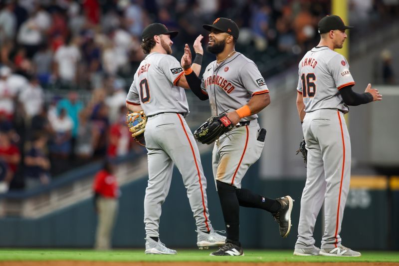 Jul 2, 2024; Atlanta, Georgia, USA; San Francisco Giants second baseman Brett Wisely (0) and center fielder Heliot Ramos (17) celebrate after a victory against the Atlanta Braves at Truist Park. Mandatory Credit: Brett Davis-USA TODAY Sports