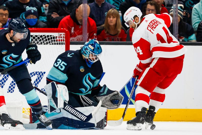 Feb 19, 2024; Seattle, Washington, USA; Detroit Red Wings center Robby Fabbri (14) misses a shot against Seattle Kraken goaltender Joey Daccord (35) during the second period at Climate Pledge Arena. Mandatory Credit: Joe Nicholson-USA TODAY Sports