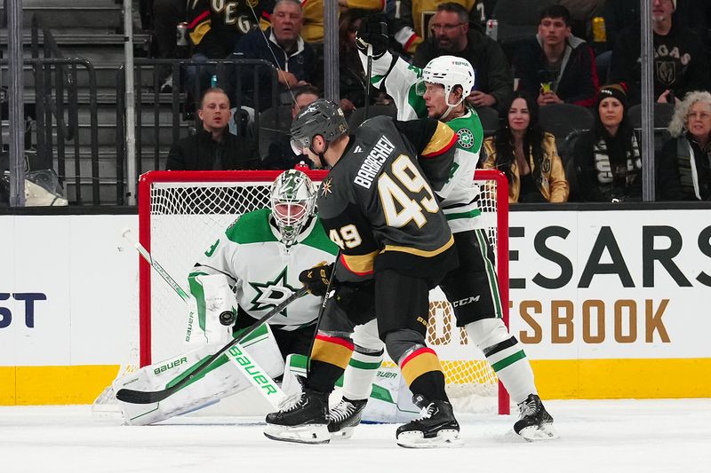 Jan 28, 2025; Las Vegas, Nevada, USA; Dallas Stars goaltender Jake Oettinger (29) looks to make a save as Vegas Golden Knights center Ivan Barbashev (49) attempts a deflection during the first period at T-Mobile Arena. Mandatory Credit: Stephen R. Sylvanie-Imagn Images