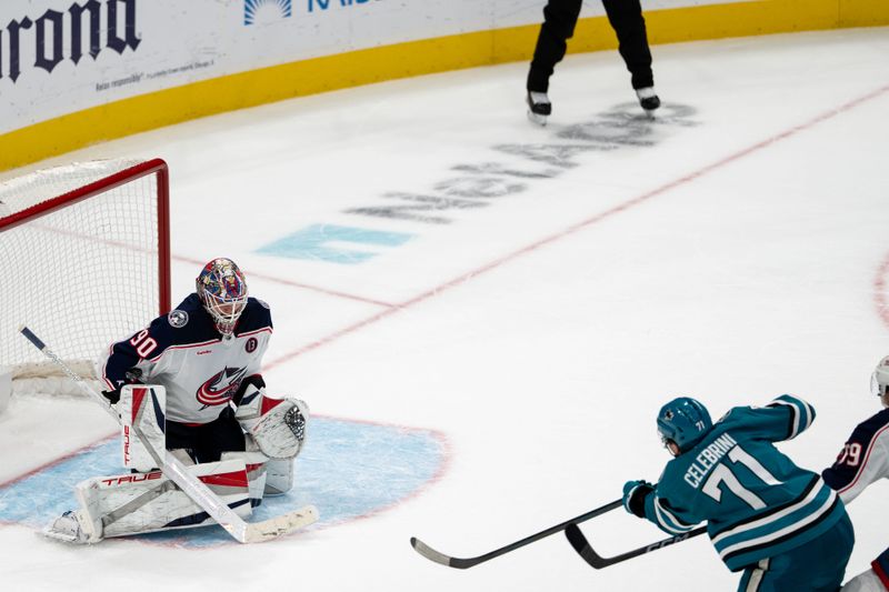 Nov 5, 2024; San Jose, California, USA;  Columbus Blue Jackets goaltender Elvis Merzlikins (90) makes a save against San Jose Sharks center Macklin Celebrini (71) during overtime at SAP Center at San Jose. Mandatory Credit: Neville E. Guard-Imagn Images