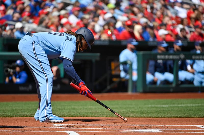 Apr 2, 2023; St. Louis, Missouri, USA;  Toronto Blue Jays first baseman Vladimir Guerrero Jr. (27) writes in the dirt before his at bat against the St. Louis Cardinals during the first inning at Busch Stadium. Mandatory Credit: Jeff Curry-USA TODAY Sports