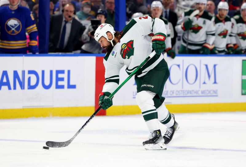 Nov 27, 2024; Buffalo, New York, USA;  Minnesota Wild defenseman Zach Bogosian (24) takes a shot on goal during the third period against the Buffalo Sabres at KeyBank Center. Mandatory Credit: Timothy T. Ludwig-Imagn Images