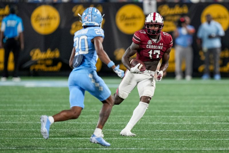 Sep 2, 2023; Charlotte, North Carolina, USA; North Carolina Tar Heels defensive back Tayon Holloway (20) chases down South Carolina Gamecocks wide receiver Xavier Legette (17) during the second half at Bank of America Stadium. Mandatory Credit: Jim Dedmon-USA TODAY Sports