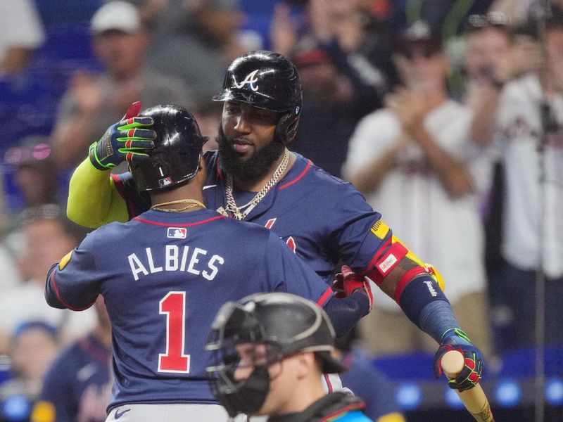 Sep 22, 2024; Miami, Florida, USA;  Atlanta Braves second baseman Ozzie Albies (1) is congratulated by designated hitter Marcell Ozuna (20) after hitting a solo home run against the Miami Marlins in the first inning at loanDepot Park. Mandatory Credit: Jim Rassol-Imagn Images