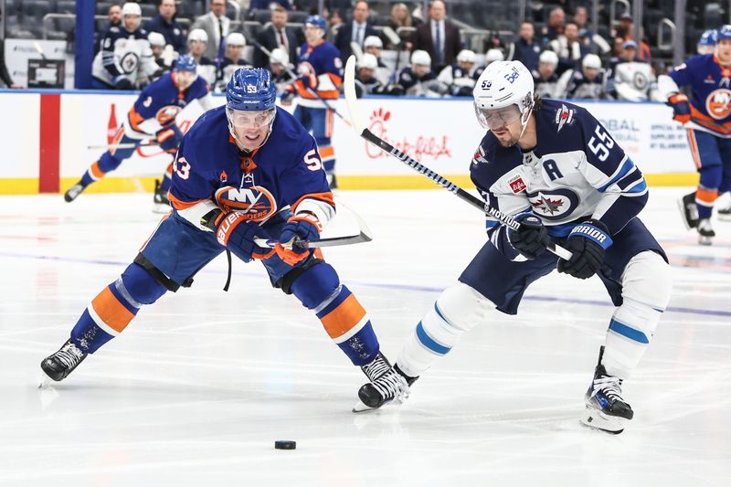 Mar 4, 2025; Elmont, New York, USA;  New York Islanders center Casey Cizikas (53) and Winnipeg Jets center Mark Scheifele (55) chase after the puck in the second period at UBS Arena. Mandatory Credit: Wendell Cruz-Imagn Images