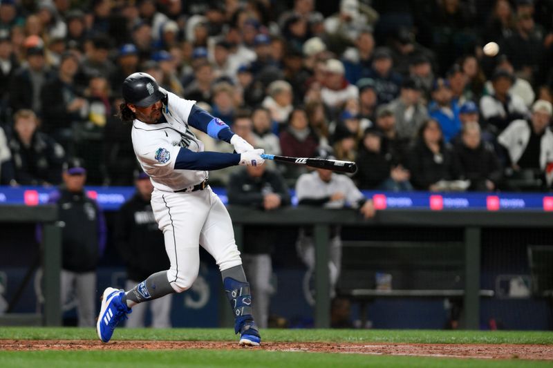 Apr 15, 2023; Seattle, Washington, USA; Seattle Mariners third baseman Eugenio Suarez (28) hits a home run against the Colorado Rockies during the fourth inning at T-Mobile Park. Mandatory Credit: Steven Bisig-USA TODAY Sports