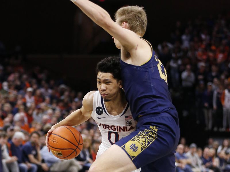 Feb 18, 2023; Charlottesville, Virginia, USA; Virginia Cavaliers guard Kihei Clark (0) controls the ball as Notre Dame Fighting Irish guard Dane Goodwin (23) defends during the second half at John Paul Jones Arena. Mandatory Credit: Amber Searls-USA TODAY Sports