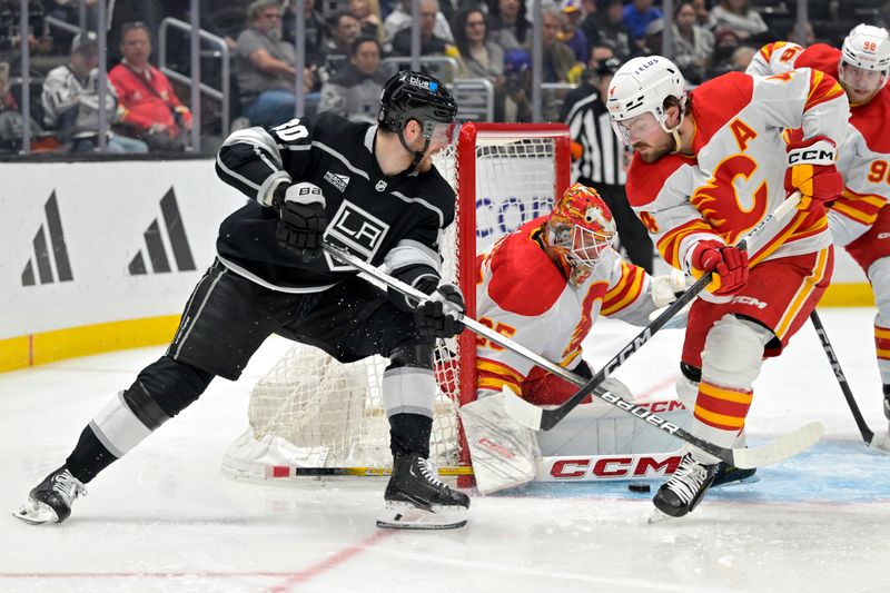 Apr 11, 2024; Los Angeles, California, USA; Calgary Flames goaltender Jacob Markstrom (25) makes a save on a shot by Los Angeles Kings center Pierre-Luc Dubois (80) as Calgary Flames defenseman Rasmus Andersson (4) looks to clear the puck in the second period at Crypto.com Arena. Mandatory Credit: Jayne Kamin-Oncea-USA TODAY Sports