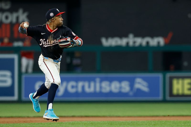 Jun 4, 2025; Washington, District of Columbia, USA; Washington Nationals shortstop Nasim Nuñez (26) makes a throw to first base on a ground ball by Chicago Cubs outfielder Ian Happ (not pictured) during the eighth inning at Nationals Park. Mandatory Credit: Geoff Burke-Imagn Images