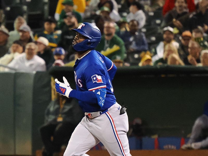 Sep 25, 2024; Oakland, California, USA; Texas Rangers right fielder Adolis Garcia (53) rounds the bases on a two-run home run against the Oakland Athletics during the third inning at Oakland-Alameda County Coliseum. Mandatory Credit: Kelley L Cox-Imagn Images