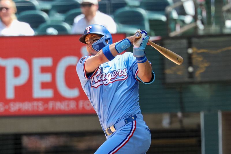 May 4, 2025; Arlington, Texas, USA;  Texas Rangers third baseman Josh Jung (6) hits an rbi single during the third inning against the Seattle Mariners at Globe Life Field. Mandatory Credit: Kevin Jairaj-Imagn Images