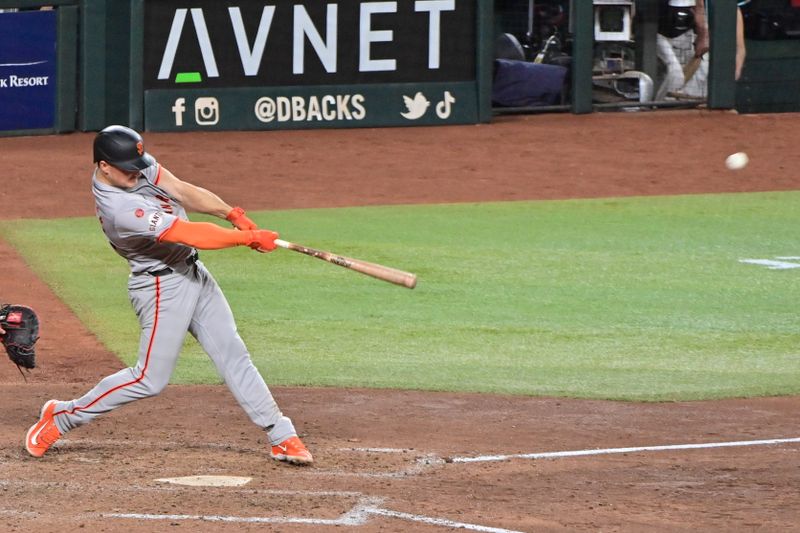 Sep 23, 2024; Phoenix, Arizona, USA;  San Francisco Giants third base Matt Chapman (26) hits a RBI triple in the seventh inning against the Arizona Diamondbacks at Chase Field. Mandatory Credit: Matt Kartozian-Imagn Images