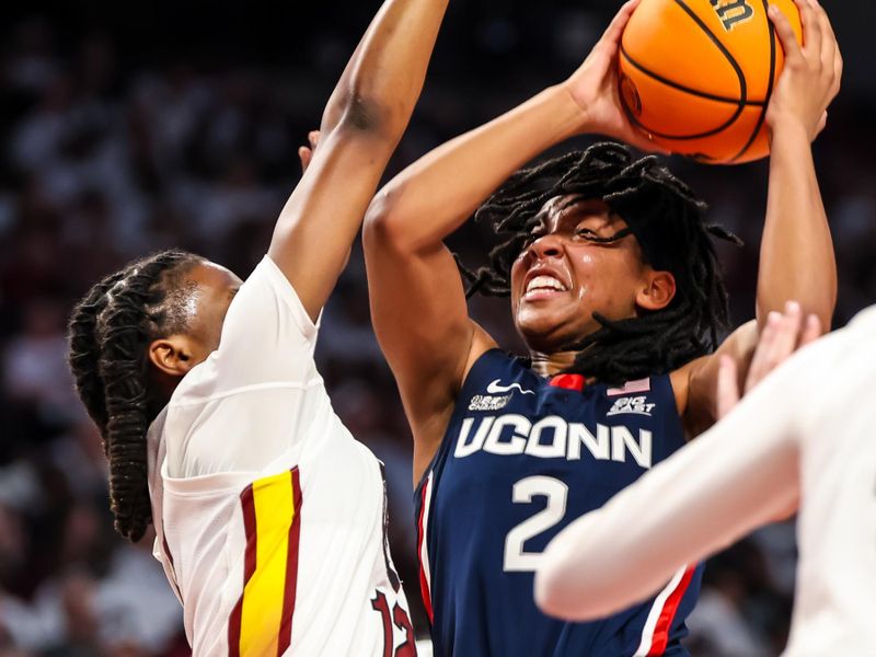 Feb 11, 2024; Columbia, South Carolina, USA; UConn Huskies guard KK Arnold (2) drives into South Carolina Gamecocks guard MiLaysia Fulwiley (12) in the second half at Colonial Life Arena. Mandatory Credit: Jeff Blake-USA TODAY Sports