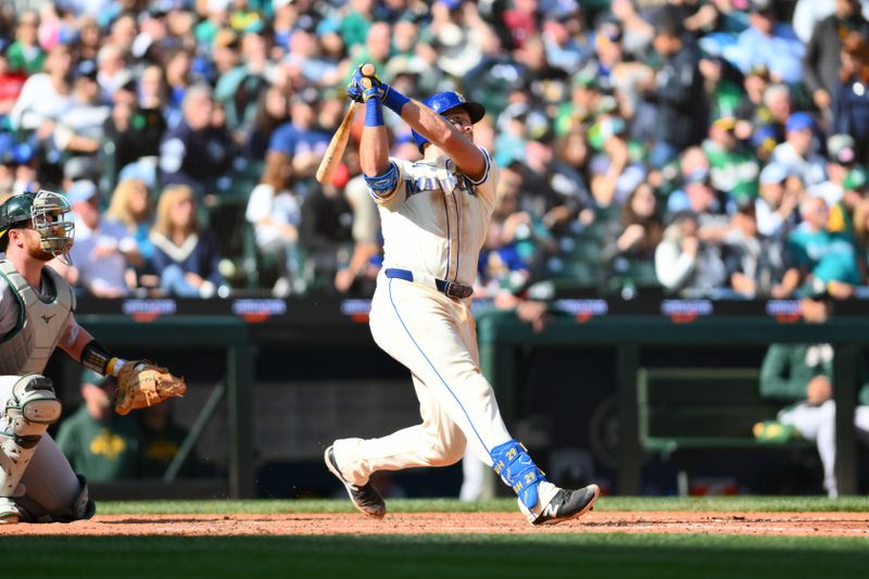 Sep 29, 2024; Seattle, Washington, USA; Seattle Mariners catcher Cal Raleigh (29) hits a 2-run home run against the Oakland Athletics during the fifth inning at T-Mobile Park. Mandatory Credit: Steven Bisig-Imagn Images