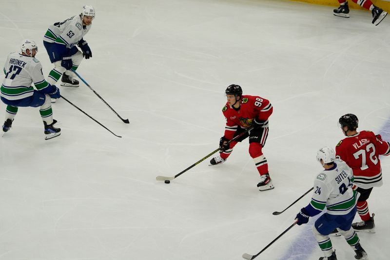 Oct 22, 2024; Chicago, Illinois, USA; Chicago Blackhawks center Connor Bedard (98) skates against the Vancouver Canucks during the third period at United Center. Mandatory Credit: David Banks-Imagn Images