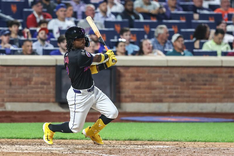 Sep 19, 2024; New York City, New York, USA;  New York Mets shortstop Luisangel Acuña (2) hits an RBI triple in the seventh inning against the Philadelphia Phillies at Citi Field. Mandatory Credit: Wendell Cruz-Imagn Images